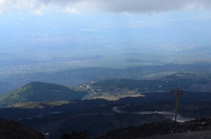 Looking back down the volcano - from the cable car.  You can see the white bus we rode as it traverses a gravelly path.