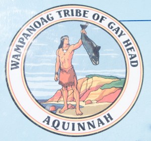 The emblem of the Wampanoag Tribe of gay Head, Aquinnah featuring the god, Moshup with a whale.