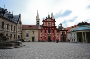 The red building with the Baroque facade is St. George's Basilica.